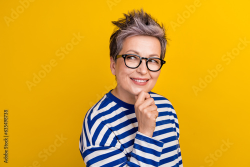 Photo of attractive woman touch chin looking information doubtful business manager create more projects isolated on yellow color background