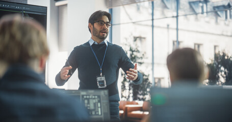 Portrait of a Teacher Giving Computer Science Lecture to Diverse Multiethnic Group of Students in a College Room. Projecting Slideshow with Programming Code. Explaining Information Technology