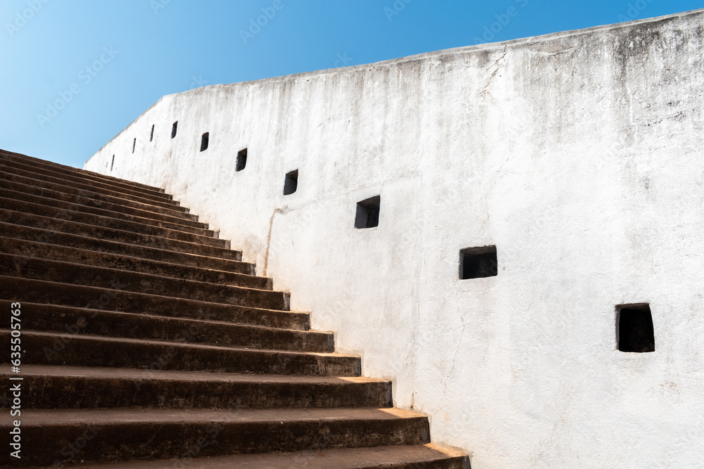 Detail of the white walls and steps leading up to the ancient watch tower built by Tipu Sultan in the village of Boloor near Mangalore.