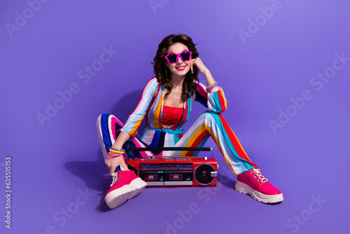 Full lenght photo of excited pretty girl dressed striped overall enjoying boombox disco music isolated violet color background