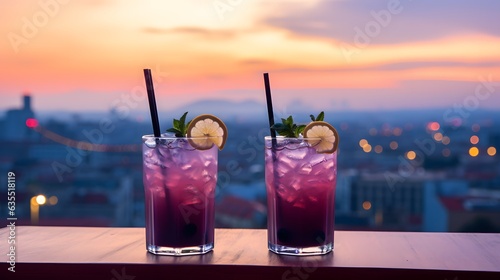 Two blue and purple coctails, city in the background at night, clubbing concept photo