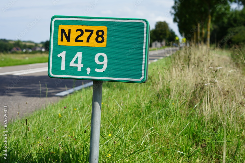 Street name sign at the provincial road N278 between Dutch cities Maastricht and Vaals with kilometer distance, 14.9 kilometers from Maastricht and near the village Wahlwiller