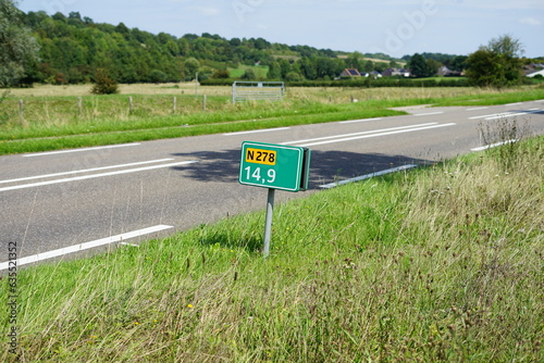 Street name sign at the provincial road N278 between Dutch cities Maastricht and Vaals near the village Wahlwiller, with the Limburg hills in the background