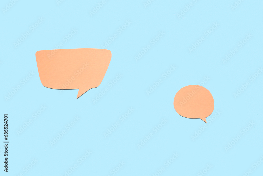 Blank paper speech bubbles on blue background Blank paper speech bubbles on blue background