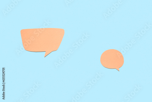 Two orange paper speech bub...