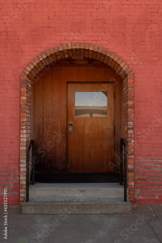 orange red arch doorway side street entrance with wood door