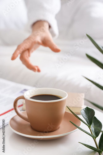 Woman in bathrobe taking cu...