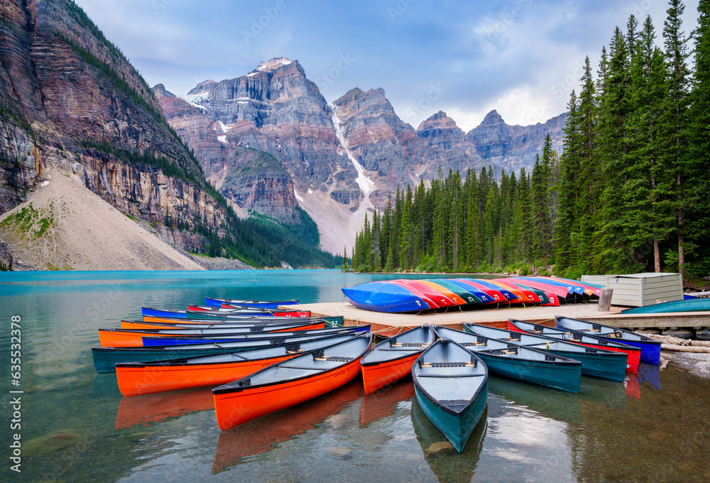 Colorful Canoes, Moraine Lake during summer in .Banff National Park, Canadian Rockies, Alberta, Canada...Banff National Park, Alberta, Canada