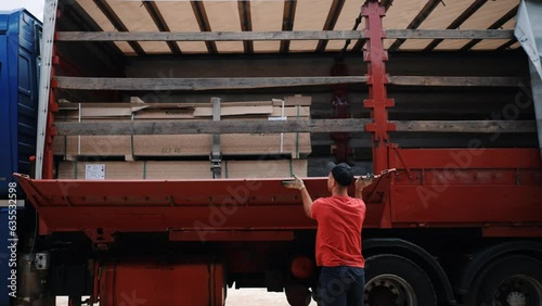 truck for transportation. A man unloads furniture