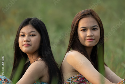 two asian beautiful grils in the field photo