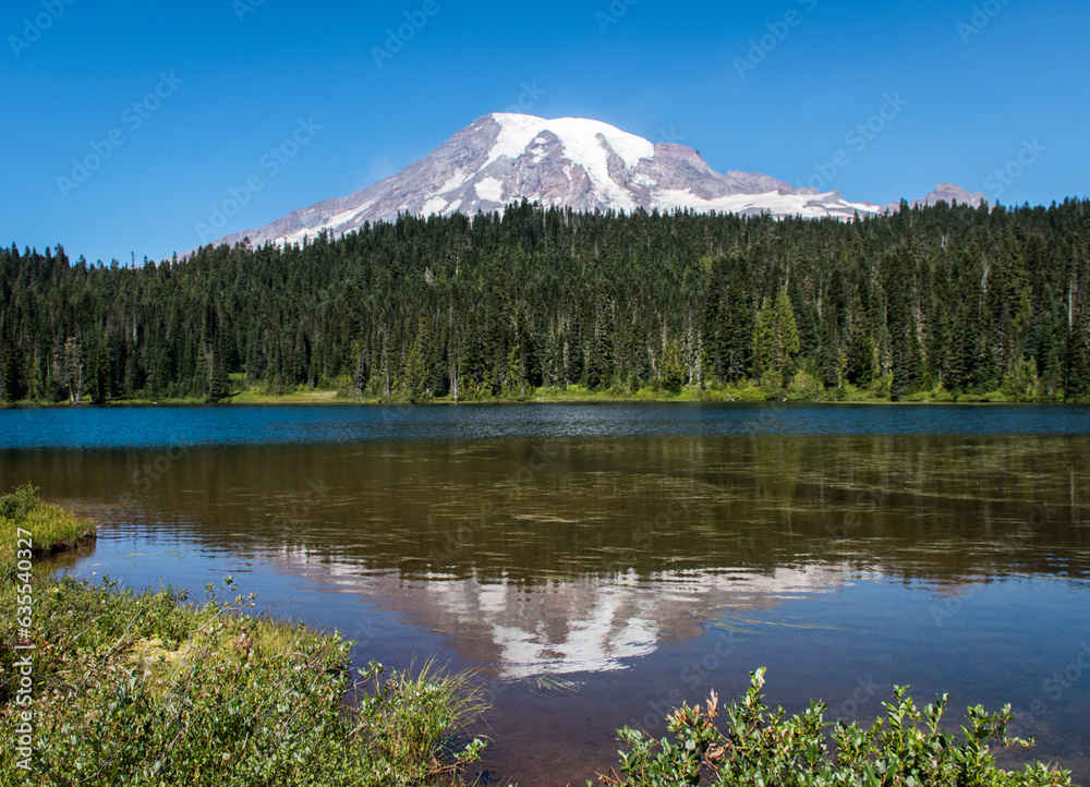 Tranquil Wilderness: Reflection of Nature's Beauty in Clear Sky over Mountain Lake