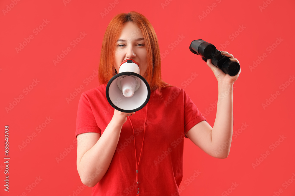 Fototapeta premium Female lifeguard with binoculars shouting into megaphone on red background