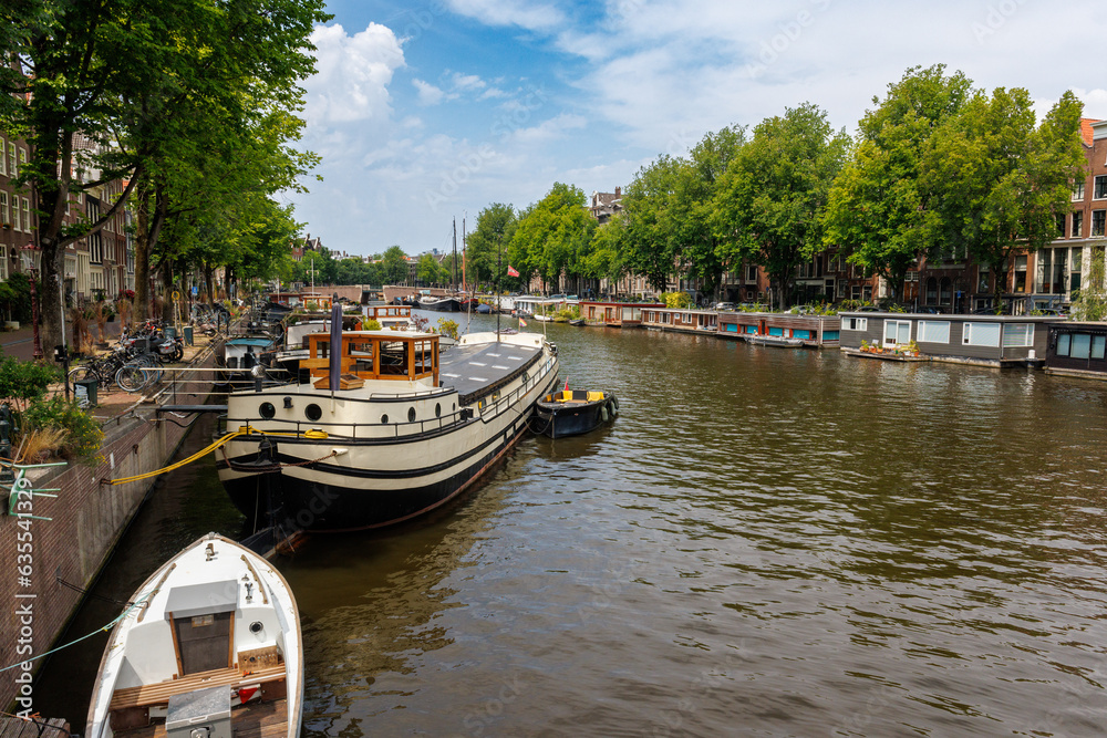 Boats tied up in canal in Amsterdam