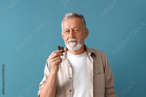Mature man with tasty choco...