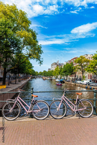 Pink bikes along canal in Amsterdam