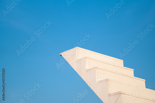 ascending the Ladder of Success,Reaching New Heights on a White Staircase against a Bright Sky Background, Climbing Towards Ambition,The Journey of Progress