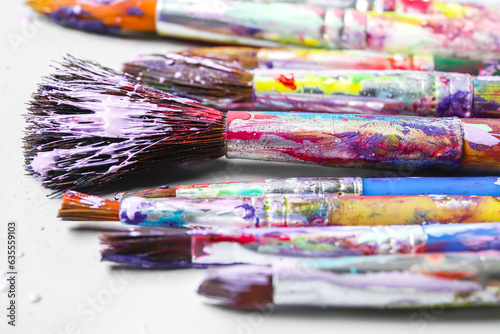 Dirty paint brushes on white background