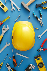 Acknowledge the meaningful contributions of construction workers this Labor Day. Top view vertical photo of safety helmet, building instruments on blue background
