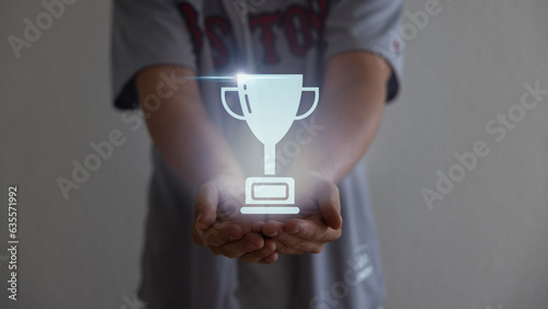 Close up man hands holding champion golden trophy isolated over background.