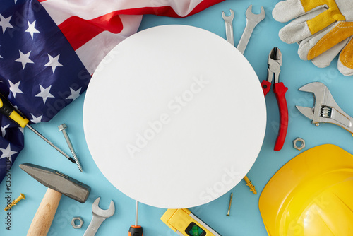 Design a captivating happy Labor Day banner. Top view composition of national american flag, helmet, gloves, tools on pastel blue background with blank circle for advert or message