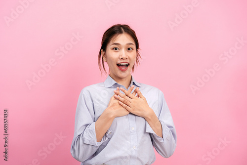 Young asian woman use both hands touching on the chest and open mouth while feeling shocked and scared