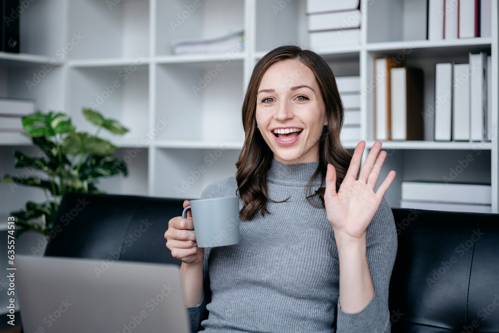 Businesswoman with technology lifestyle concept, Businesswoman using laptop to video conference and greeting with colleague while sitting on the couch to relaxation with technology after working Businesswoman with technology lifestyle concept, Businesswoman using laptop to video conference and greeting with colleague while sitting on the couch to relaxation with technology after working