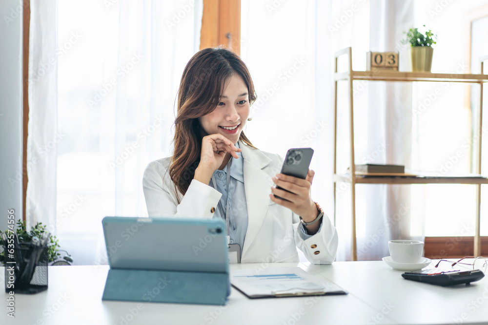 Businesswoman in suit using smartphone to chatting with partners while reading business document and working Businesswoman in suit using smartphone to chatting with partners while reading business document and working