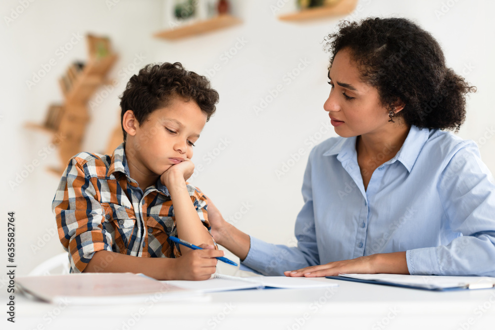Obraz premium Mom Comforting Unhappy Schoolboy Son Having Issue With Homework Indoors