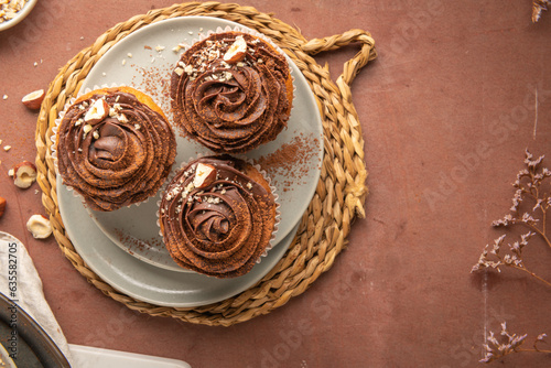 Chocolate chip muffins decorated with chocolate ganache and hazelnut