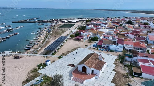 Aerial view of the port, church and Isla de La Culatra. Lighthouse district. Marshes and salt flats of the Ria Formosa Natural Park. Atlantic Ocean. Algarve. Portugal. Europe