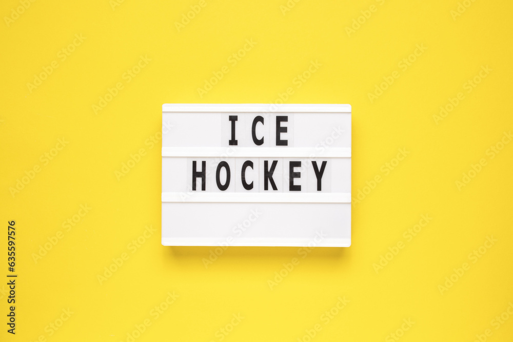 Naklejka premium The word ice hockey on lightbox isolated yellow background. Type of winter sports game.