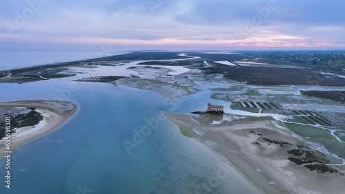 Sunset in Fuseta from an aerial drone view. Olhão Municipality. Lighthouse district. Marshes and salt flats of the Ria Formosa Natural Park. Atlantic Ocean. Algarve. Portugal. Europe