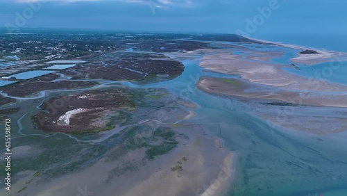 Sunset in Fuseta from an aerial drone view. Olhão Municipality. Lighthouse district. Marshes and salt flats of the Ria Formosa Natural Park. Atlantic Ocean. Algarve. Portugal. Europe