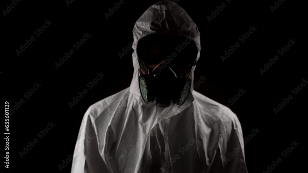 Laboratory worker in a chemical protection suit goes to the camera Laboratory worker in a chemical protection suit goes to the camera
