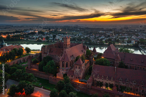 Wallpaper Mural The Castle of the Teutonic Order in Malbork by the Nogat river at sunset. Poland Torontodigital.ca