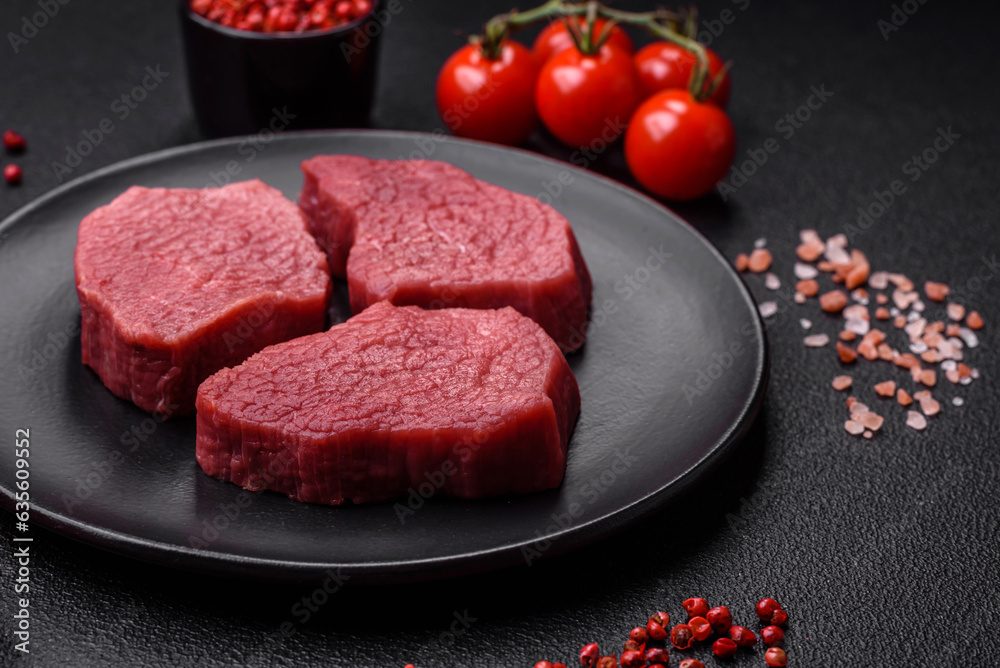 Juicy fresh raw beef meat with salt, spices and herbs Juicy fresh raw beef meat with salt, spices and herbs