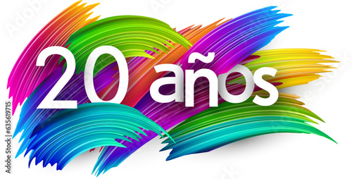 20 years at spanish paper word sign with colorful spectrum paint brush strokes over white. Vector illustration.