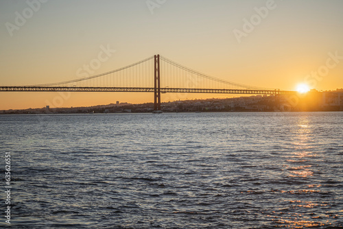 Sunset view over lisbon and 25 de Abril Bridge famous tourist landmark connecting Lisbon and Almada over Tagus river