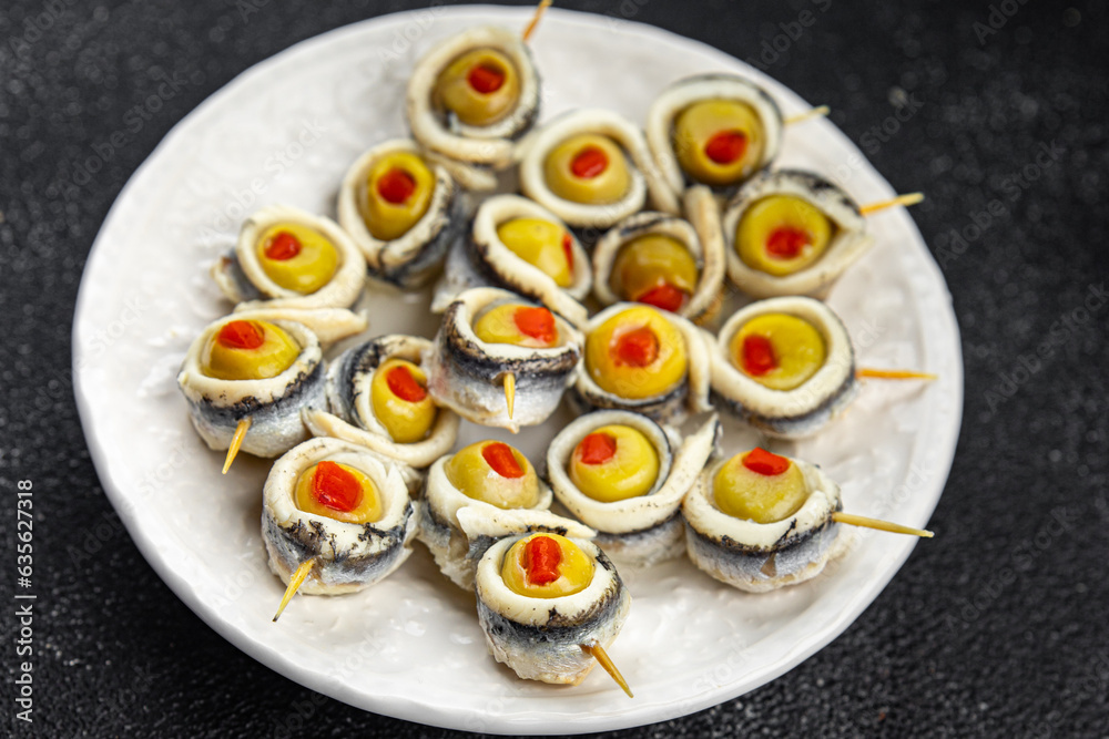 olives stuffed with anchovy fillets, anchovy rolls stuffed olives apetizing seafood pickled fish marinated ready to eat appetizer meal food snack on the table copy space food background rustic top