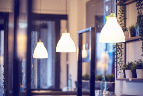 A row of lamps in the interior of the restaurant. Modern lighting fixtures as restaurant interior design