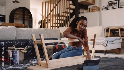 A Black Woman Fixing A Coffee Table in the Lounge photo