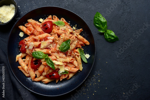 Penne pasta with grilled tomatoes. Top view with copy space.