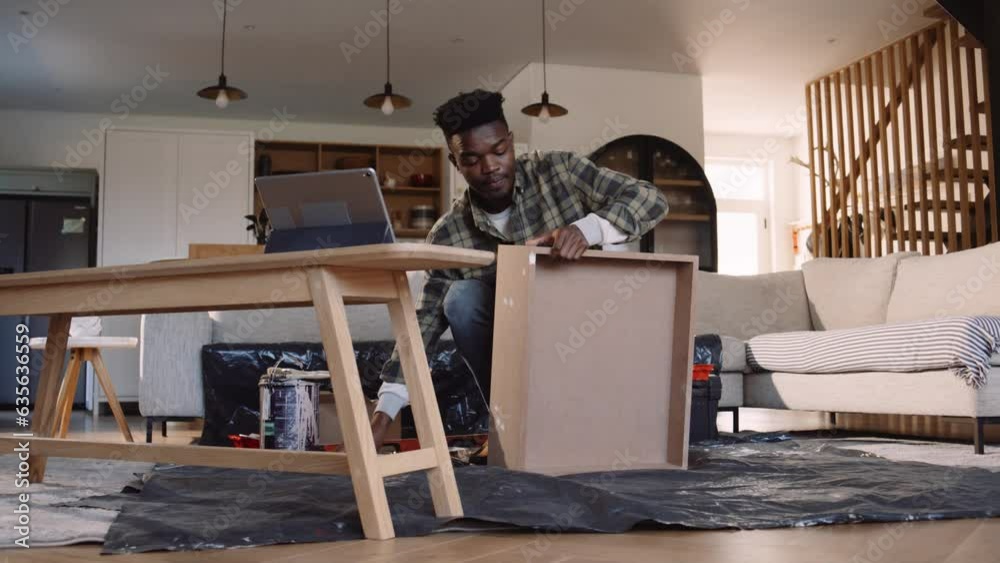 A Black Man Sanding a Drawer in the Lounge A Black Man Sanding a Drawer in the Lounge