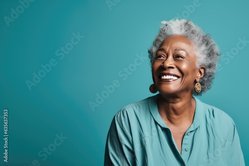 Portrait of a Mature Black Woman Looking Left on a Teal Background