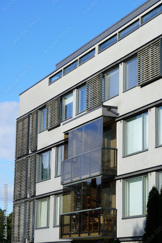 View to white appartment building with wooden details towards blue sky. Tallinn, Estonia View to white appartment building with wooden details towards blue sky. Tallinn, Estonia