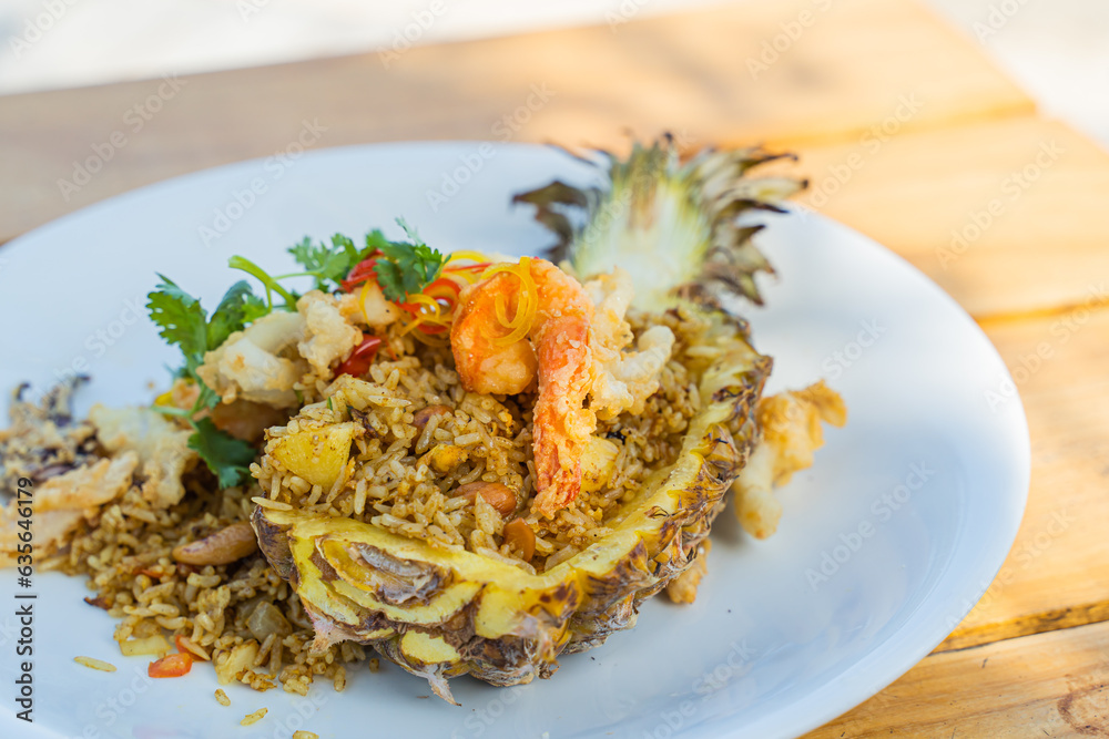 Seafood fried rice in pineapple, appetizing in a cafe next to the sea, Sue Flamingo, Ao Yon Beach, Phuket Thailand Seafood fried rice in pineapple, appetizing in a cafe next to the sea, Sue Flamingo, Ao Yon Beach, Phuket Thailand