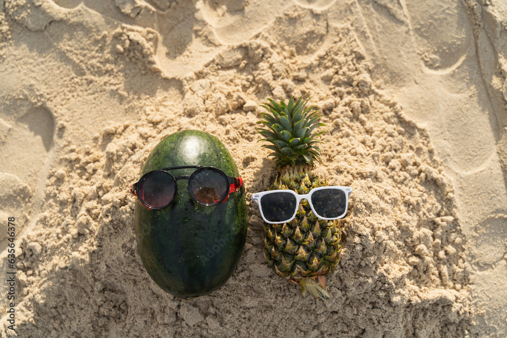 Obraz premium Fruit man made of pineapple and watermelon on the beach fruit tourism for health Funny and cute sunbathing fruits. Festive food. Summer travel concept. white background design invitation to visit