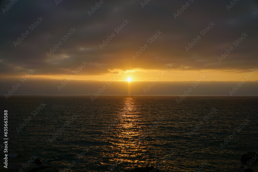 Horizontal image showcasing the mesmerizing hues of a vivid orange sunset over the tranquil sea in Viña del Mar, evoking a sense of calm and wonder.