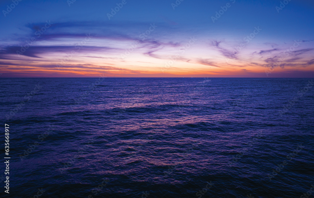 Aerial view sunset sky,Nature beautiful Light Sunset or sunrise over sea,Colorful dramatic majestic scenery Sky with Amazing clouds and waves in sunset sky purple light cloud background