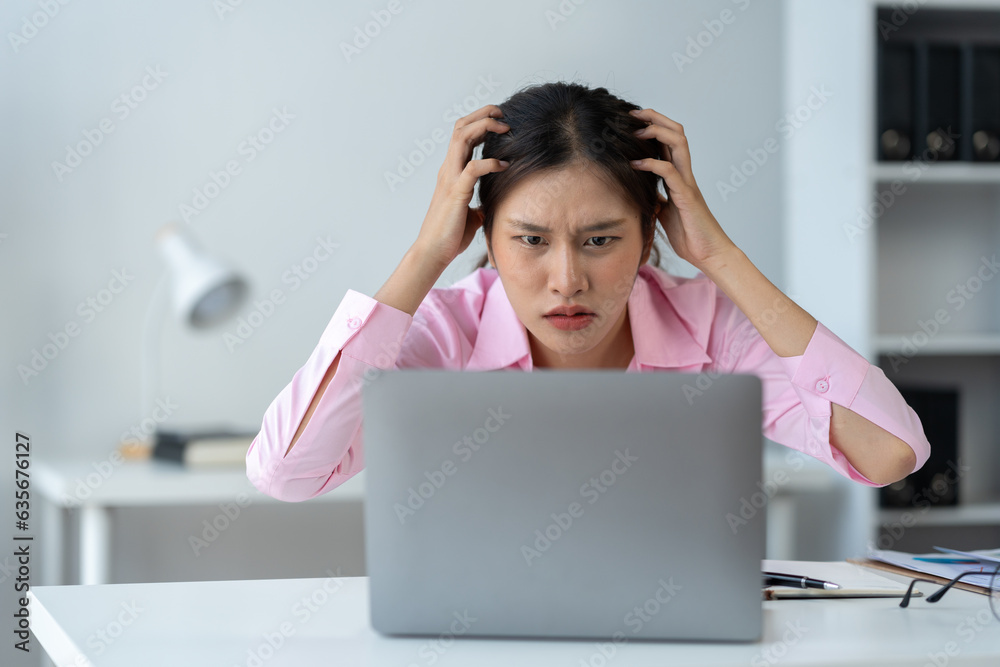 Tired Asian businesswoman, headache, stressed, sleepy and bored from sitting at a table for a long time and have office syndrome. Tired Asian businesswoman, headache, stressed, sleepy and bored from sitting at a table for a long time and have office syndrome.